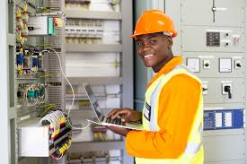 Person with hard hat next to a controller panel