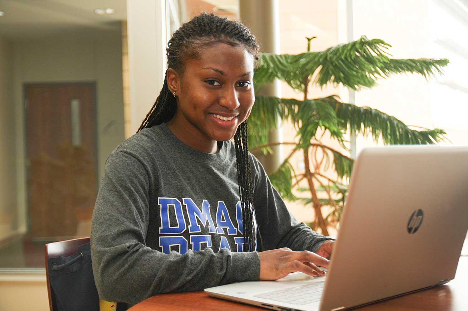 DMACC student at laptop