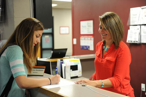 Registration desk with a student and staff